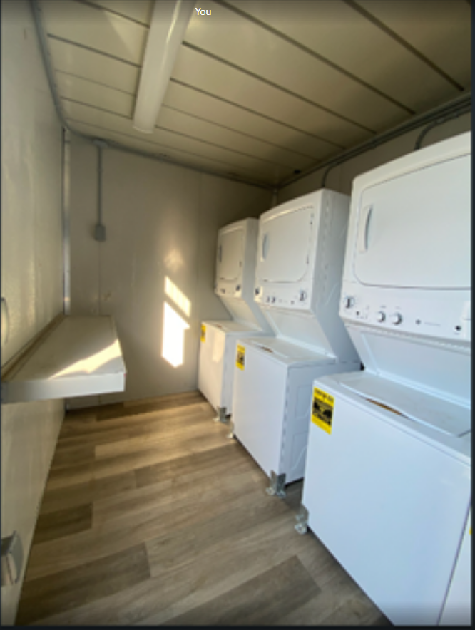 Laundry machines inside a containerized laundry facility