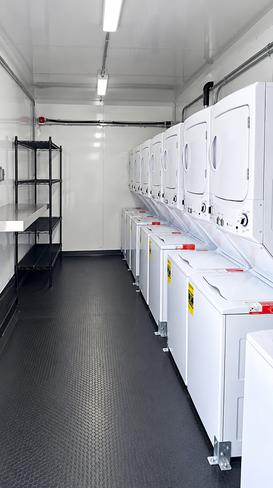 Rows of commercial washers and dryers in a laundry trailer