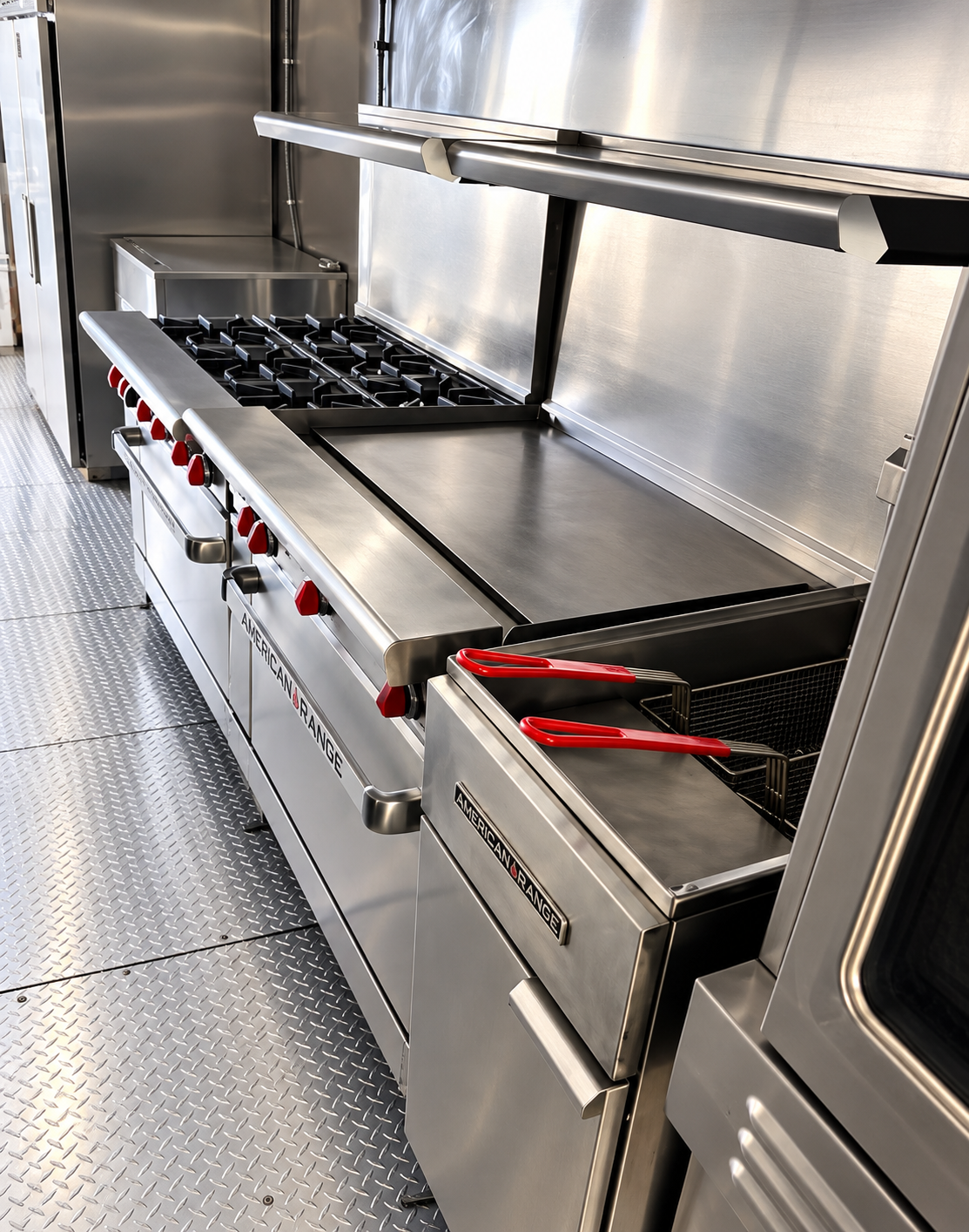 Range, griddle and fryer inside a mobile kitchen trailer